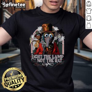 Good Light The Lamp Not The Rat Christmas T-Shirt featuring festive graphics and playful holiday themes for winter celebrations.