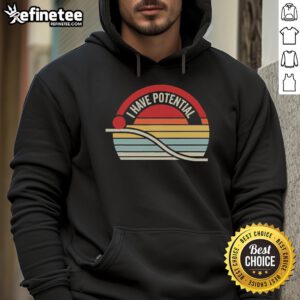 Person wearing 'I Have Potential' inspirational sunset hoodie against a vibrant sunset backdrop, embodying motivation and positivity.