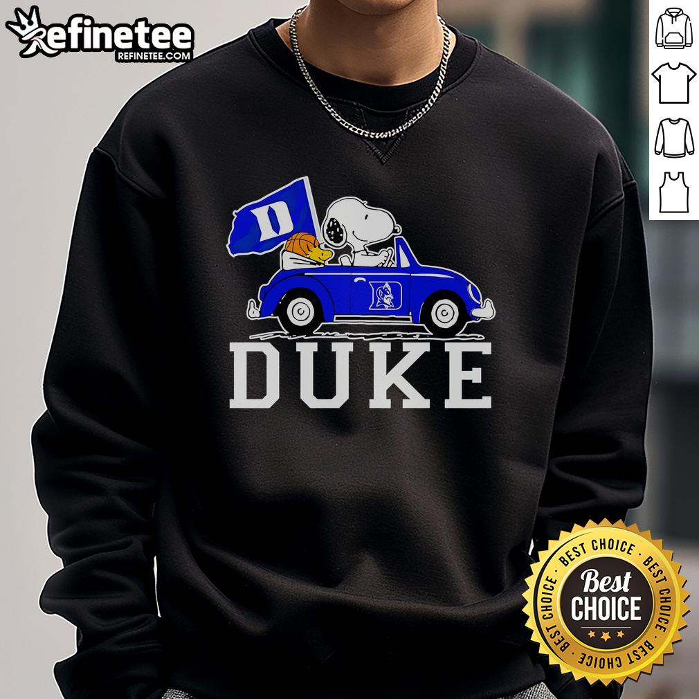Alt Text: Snoopy and Woodstock driving in a Duke Blue Devils basketball sweatshirt, showcasing team spirit and fun.