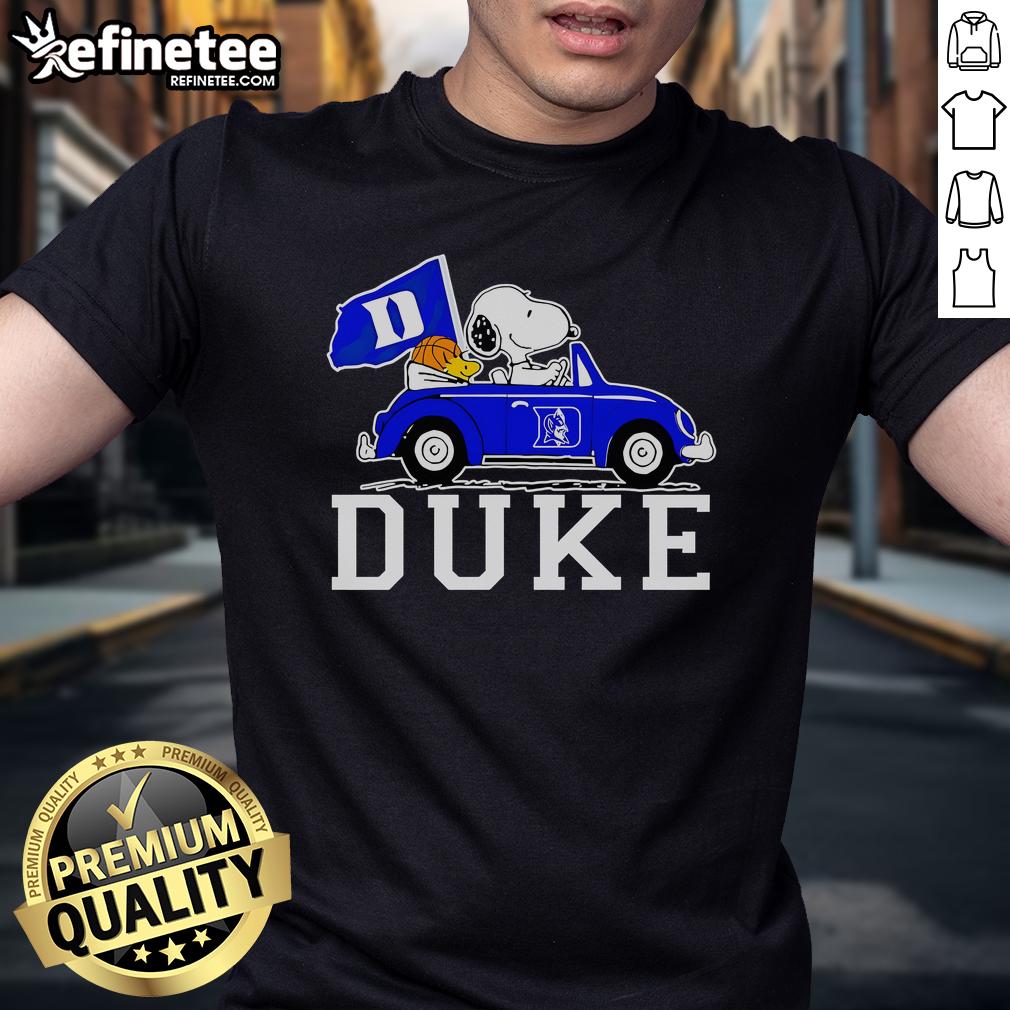 Alt Text: Snoopy and Woodstock driving a car on a Duke Blue Devils basketball T-shirt, showcasing team spirit and fun.