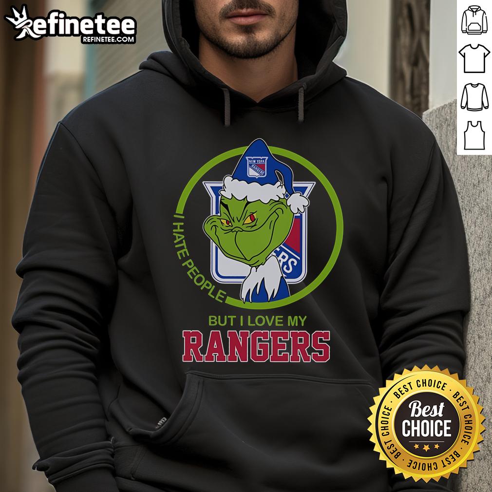 Person wearing a 'I Hate People But I Love My Rangers' hoodie inspired by The Grinch, showcasing holiday spirit.