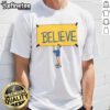 Alt Text: Official Ted Lasso Believe T-Shirt featuring a motivational design with the iconic Believe slogan in bold lettering.