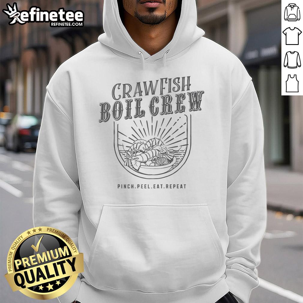 Group enjoying a crawfish boil wearing 'Pinch, Peel, Eat, Repeat' hoodies, celebrating seafood and fun times together.