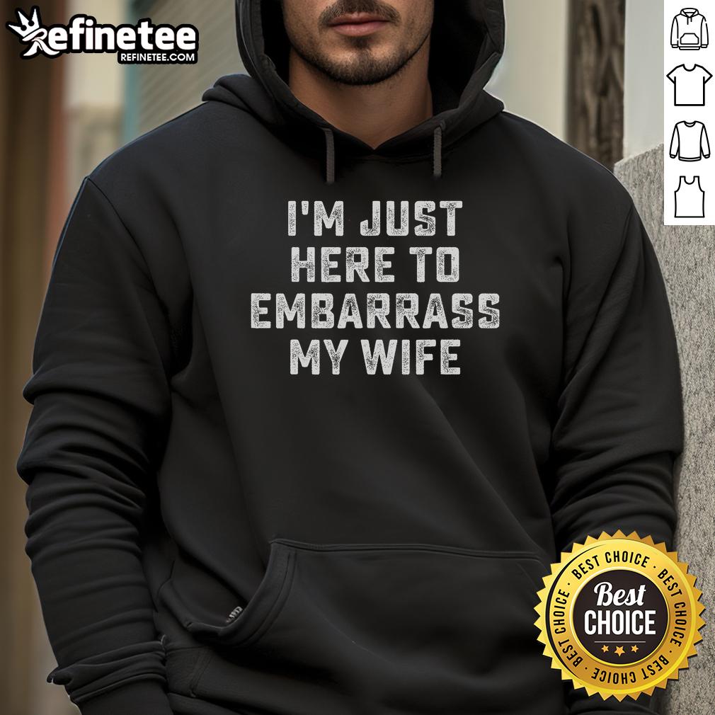 Funny 'I'm Just Here to Embarrass My Wife' hoodie on display, perfect for playful couples and humorous gifts.