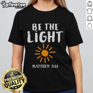 Christian ladies tee featuring 'Be The Light' design inspired by Matthew 5:14, perfect for faith-filled fashion.