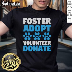 Volunteer in a 'Foster Adopt Donate' T-shirt supporting animal rescue for dogs and cats at a shelter.