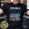 Person on a boat wearing swim trunks and a floppy t-shirt, enjoying a sunny day on the water, embodying 'Nice, I'm on a Boat' vibe.