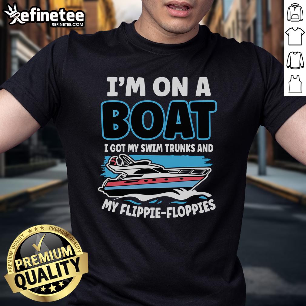 Person on a boat wearing swim trunks and a floppy t-shirt, enjoying a sunny day on the water, embodying 'Nice, I'm on a Boat' vibe.