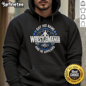 Alt Text: Joe Hendry wearing a WrestleMania hoodie, showcasing his catchphrase 'Say His Name' at a wrestling event.