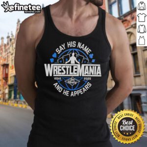 Alt Text: Joe Hendry wearing a 'Say His Name' Wrestlemania tank top, showcasing his wrestling persona and vibrant style.