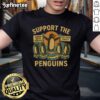 Marching penguins design on a retro t-shirt promoting economic freedom and resistance against tariffs.