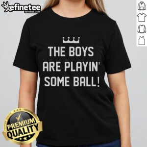 Nice the boy playing ball in a stylish ladies tee, showcasing fun outdoor activity and casual fashion for women.
