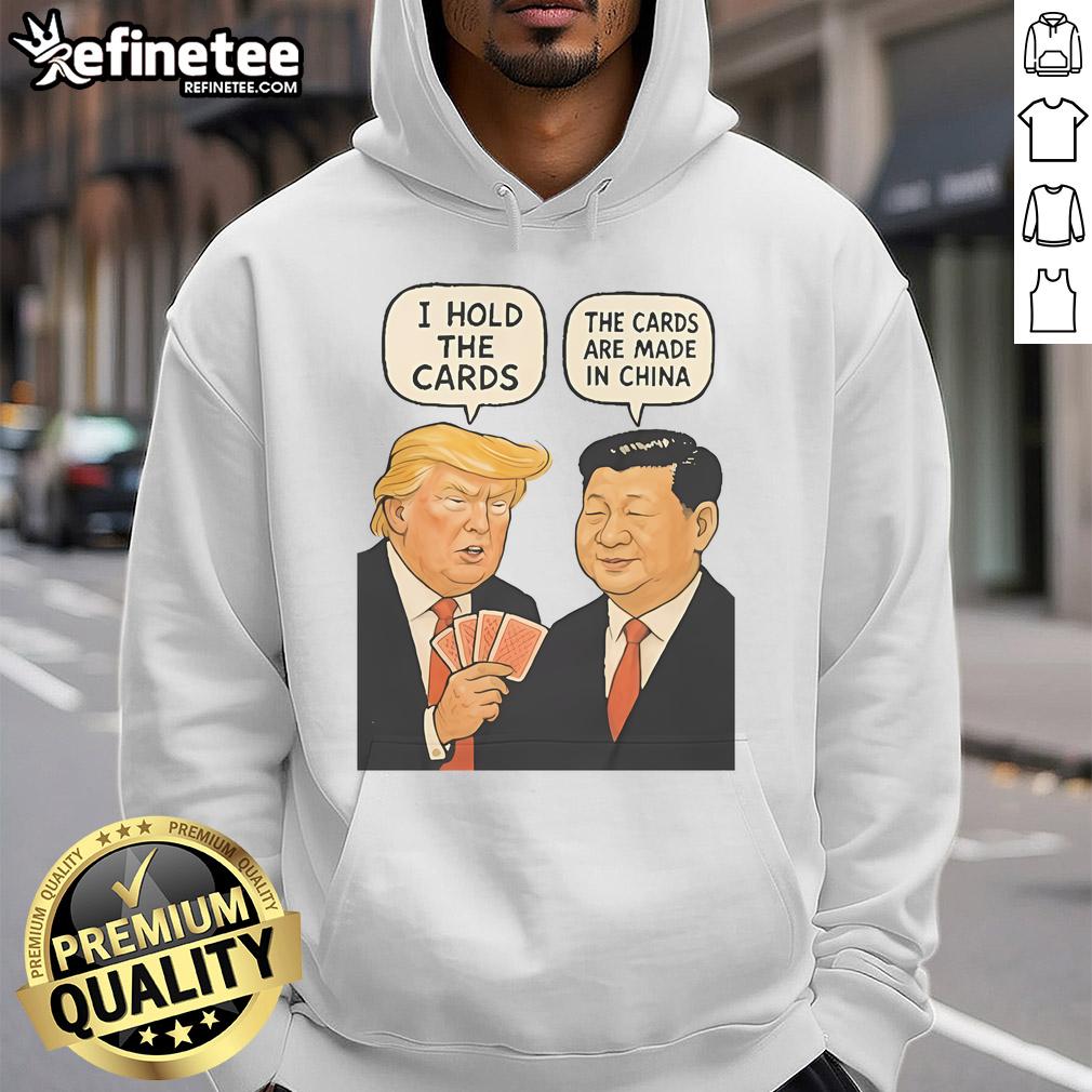 Alt Text: Official Trump 'I Hold The Cards, The Cards Are Made In China' Hoodie featuring bold text and patriotic colors.