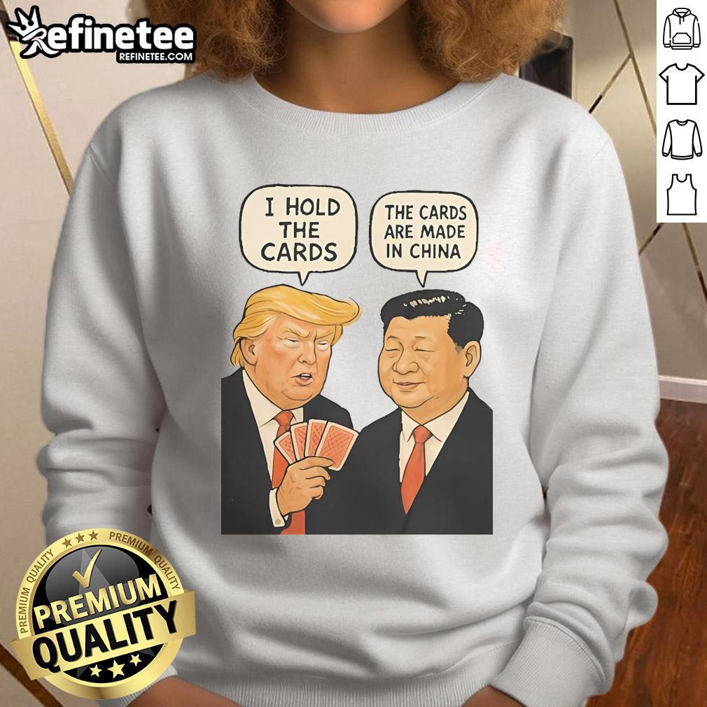 Alt Text: Official Trump sweatshirt featuring 'I Hold The Cards, The Cards Are Made In China' design in bold text.