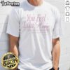 Pretty You Feel Like Home Lonely Ghost T-Shirt displayed in an emporium, showcasing its unique design and comfort.