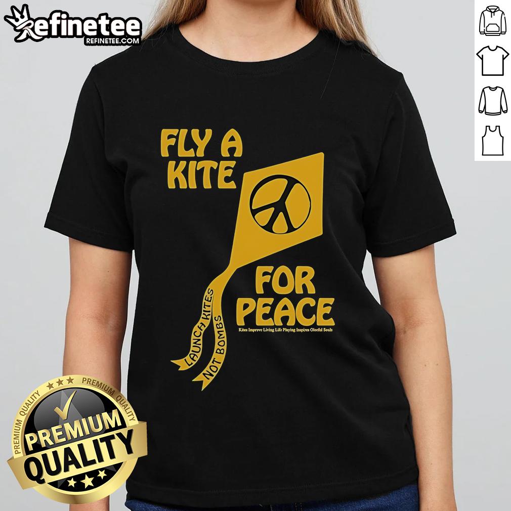 Women enjoying a sunny day flying colorful kites for peace, promoting 'Kites Not Bombs' message on a vibrant tee.