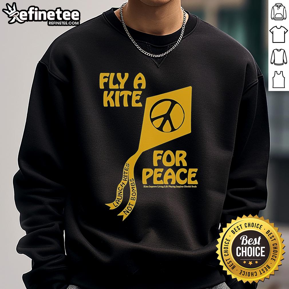 Colorful kites flying in the sky with the phrase 'Kites Improve Living' on a sweatshirt promoting peace and joy.