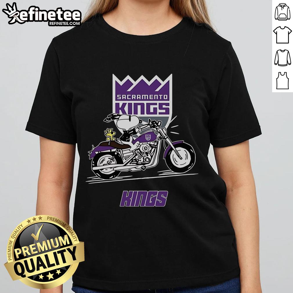 Snoopy and Woodstock riding a motorbike on a Sacramento Kings ladies tee, showcasing playful team spirit.