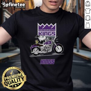 Alt Text: Snoopy and Woodstock riding a motorbike on a Sacramento Kings T-shirt, perfect for fans of the team and Peanuts.