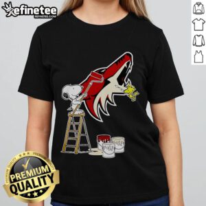 Alt Text: Official Snoopy and Woodstock painting on Arizona Coyotes logo ladies tee shirt, perfect for fans and collectors.