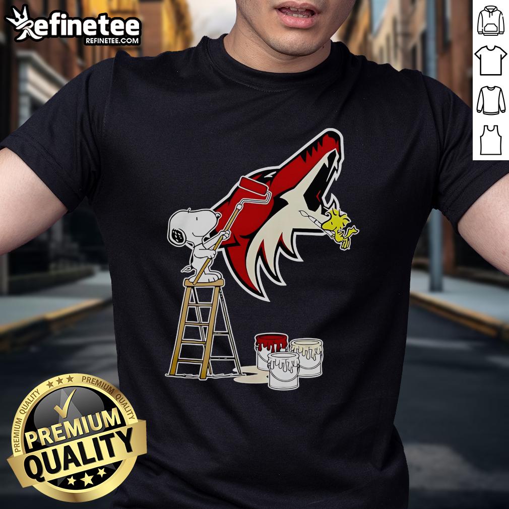 Alt Text: Official Snoopy and Woodstock painting Arizona Coyotes logo t-shirt featuring vibrant colors and iconic characters.