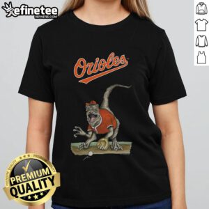 Alt Text: Official Baltimore Orioles Tiny Turnip Velociraptor Ladies Tee featuring a fun dinosaur design for fans.