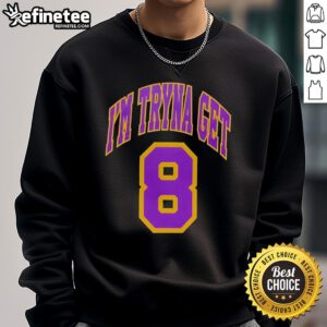 Alt Text: Kehlani wearing 'I'm Tryna Get Los Angeles Lakers 8' sweatshirt, showcasing stylish NBA fan fashion.