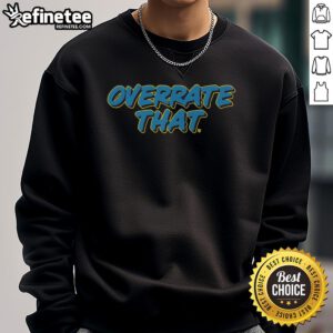 Alt Text: Pat McAfee wearing an Overrate That sweatshirt, showcasing his unique style and personality in a casual setting.