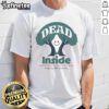 Happy Riki Lindhome wearing a 'Dead Inside' play T-shirt, showcasing a fun and quirky graphic design.