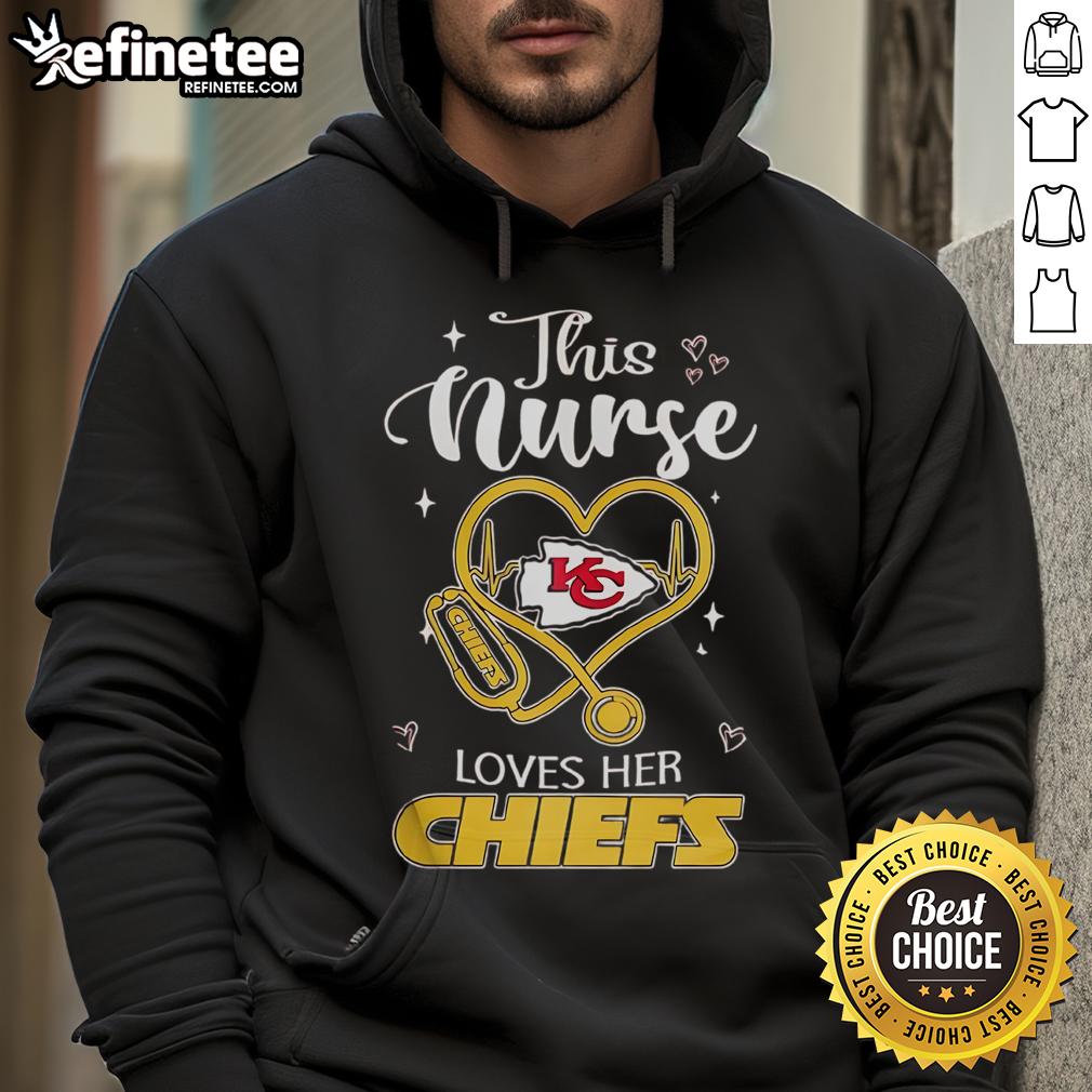 Happy nurse wearing a Kansas City Chiefs hoodie, celebrating her team spirit and dedication in a cheerful setting.