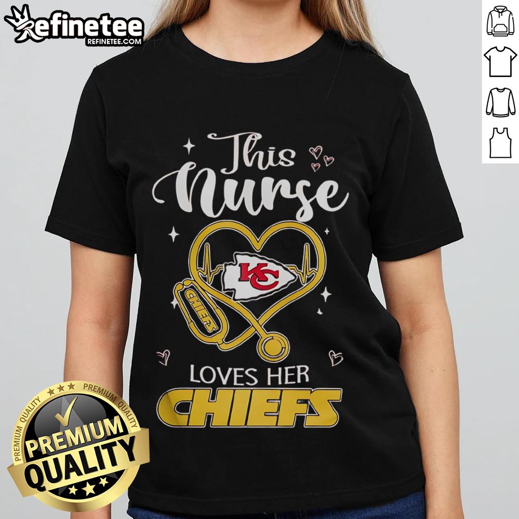 Happy nurse wearing Kansas City Chiefs ladies tee, showcasing team spirit and love for football in her cheerful demeanor.