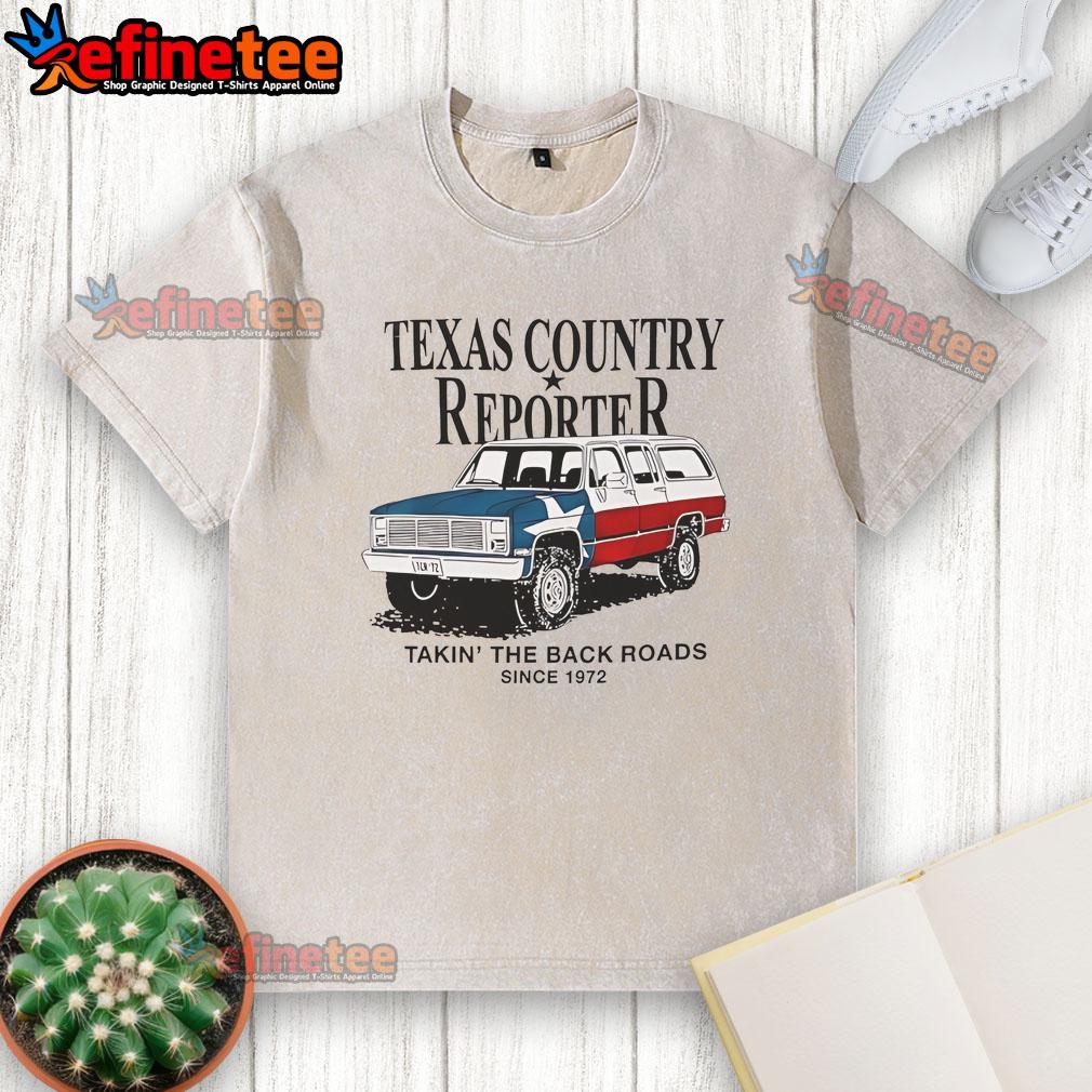 Alt Text: Nice Texas country reporter on back roads since 1972, featuring American flag car and washed T-shirt style.
