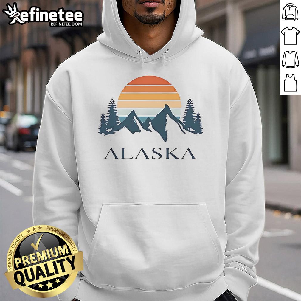 Vintage Alaska mountain camping adventure hoodie worn by travel enthusiast in a scenic outdoor setting.