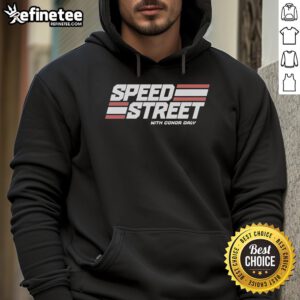 Conor Daly wearing a Top Speed Street hoodie, showcasing vibrant design and racing spirit in a dynamic urban setting.