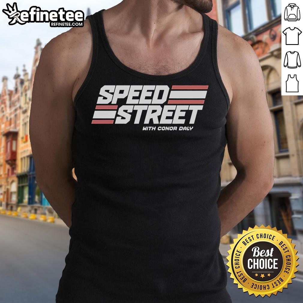 Conor Daly in a tank top on a vibrant street during Top Speed Street event, capturing high-energy racing vibes.