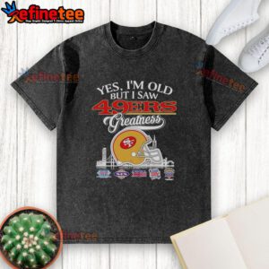 Vintage San Francisco 49ers helmet graphic on a washed t-shirt with city skyline, celebrating football greatness.