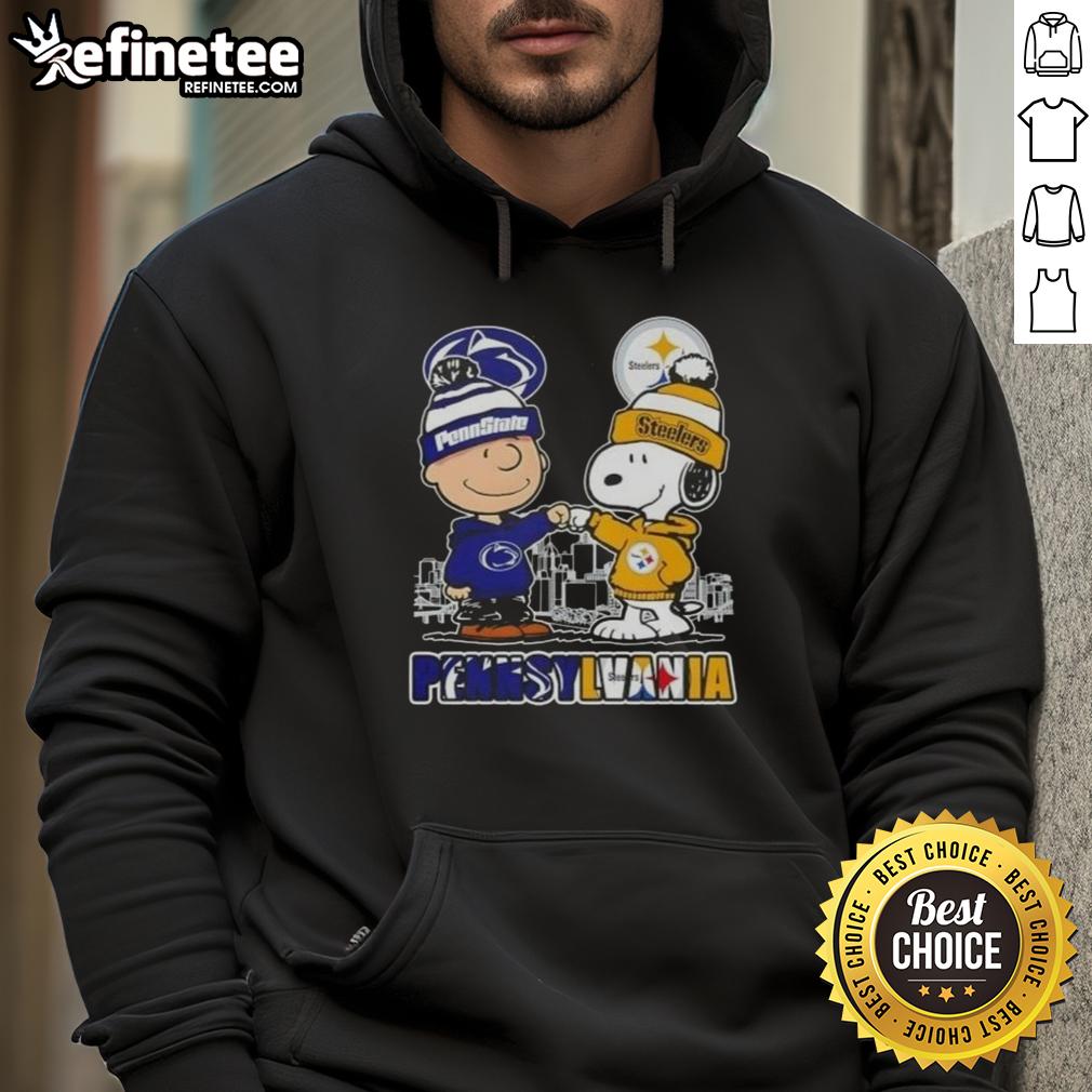 Happy Charlie Brown wearing Penn State Nittany Lions x Snoopy hoodie with Pittsburgh Steelers skyline in the background.