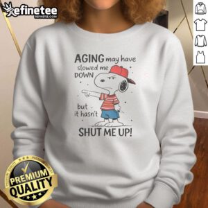 Funny Snoopy sweatshirt featuring the phrase 'Aging May Have Slowed Me Down, But It Hasn't Shut Me Up' for playful style.