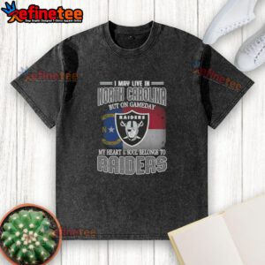 Good I May Live in North Carolina But On Gameday My Heart and Soul Belongs to Raiders washed t-shirt displayed on a hanger.