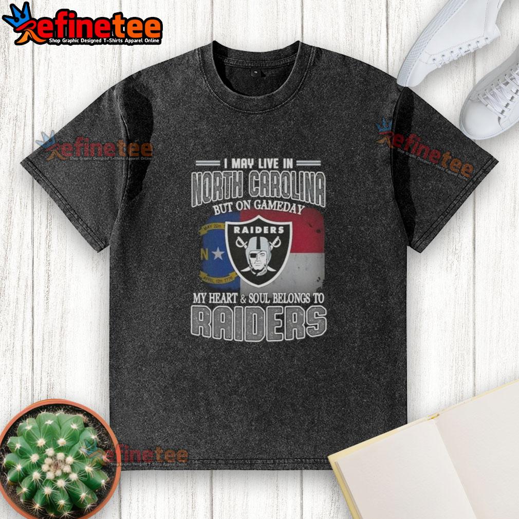 Good I May Live in North Carolina But On Gameday My Heart and Soul Belongs to Raiders washed t-shirt displayed on a hanger.