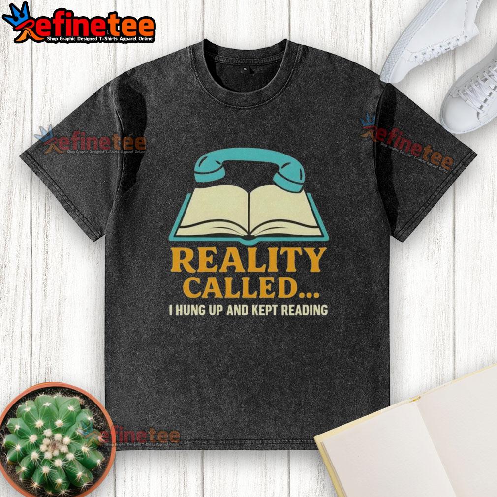 Alt Text: Person wearing a 'Hung Up And Kept Reading' washed t-shirt, immersed in a book in a cozy setting.
