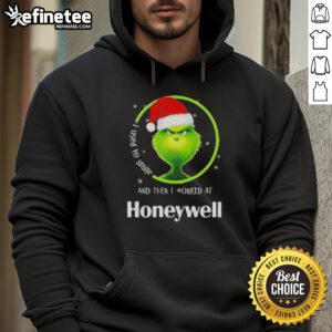 Funny Grinch Christmas hoodie featuring 'I Used to Smile and Then I Worked at Honeywell' design for festive humor.