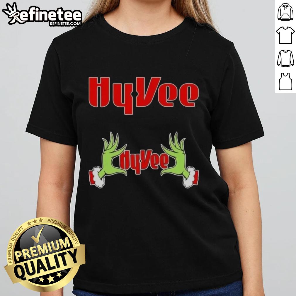 Original Grinch hands holding a heart on a Hy-Vee Christmas ladies tee, perfect for festive holiday celebrations.
