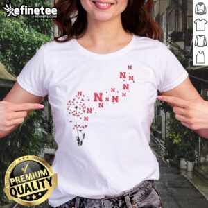Pretty dandelion flower design with Nebraska Huskers football logo on a ladies' tee shirt, perfect for fans.