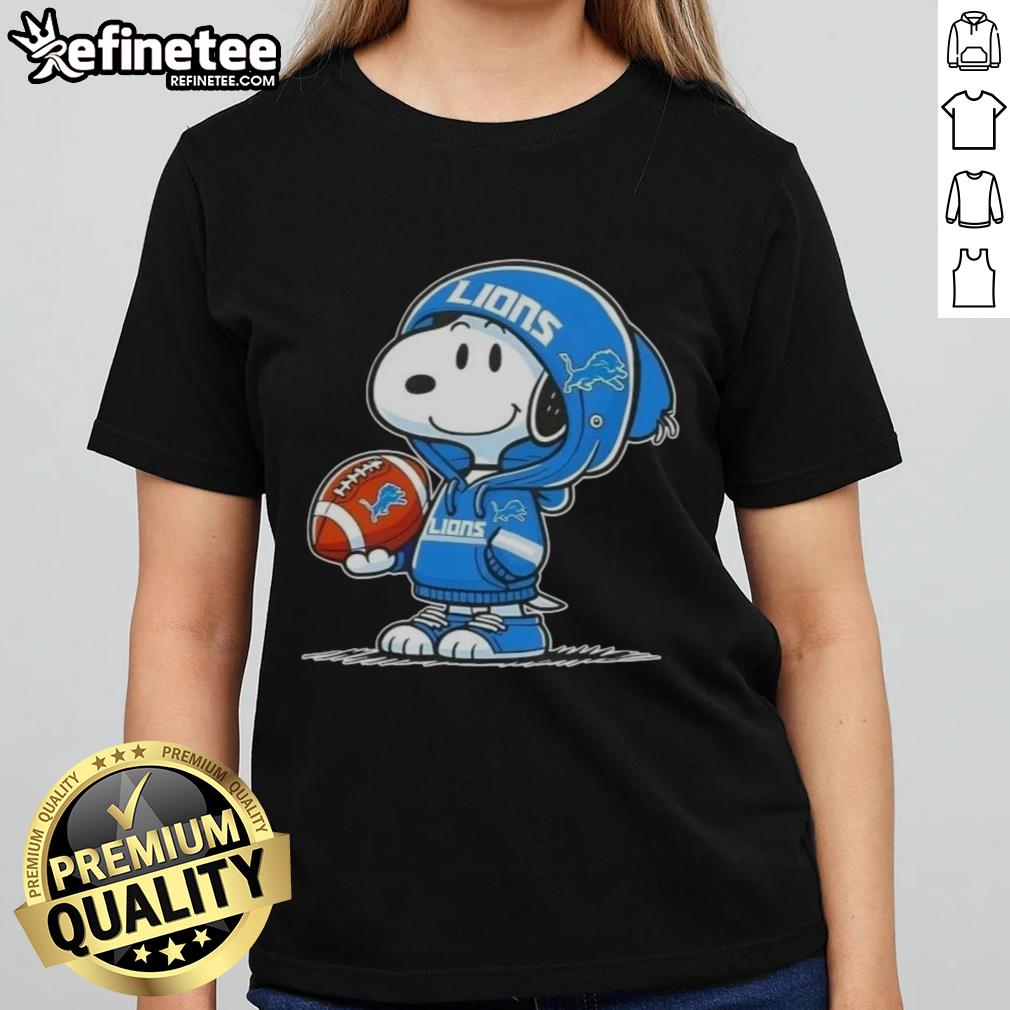 Snoopy in a Detroit Lions hoodie smiling at fans, featured on an awesome ladies tee with peanuts design.
