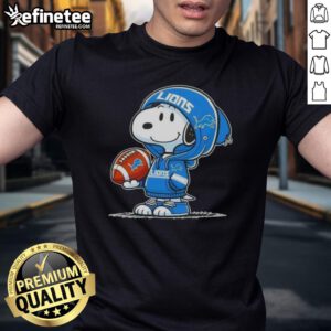 Alt Text: Snoopy in a hoodie smiling at fans on a Detroit Lions T-shirt, showcasing awesome Peanuts character design.
