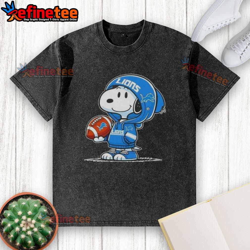 Snoopy in a hoodie, smiling at fans on a washed Detroit Lions t-shirt, showcasing awesome Peanuts character design.