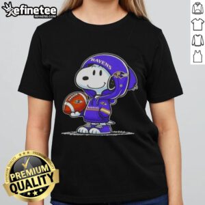 Premium Peanuts Snoopy in a Baltimore Ravens hoodie smiles at fans on a ladies tee, showcasing fun NFL spirit.