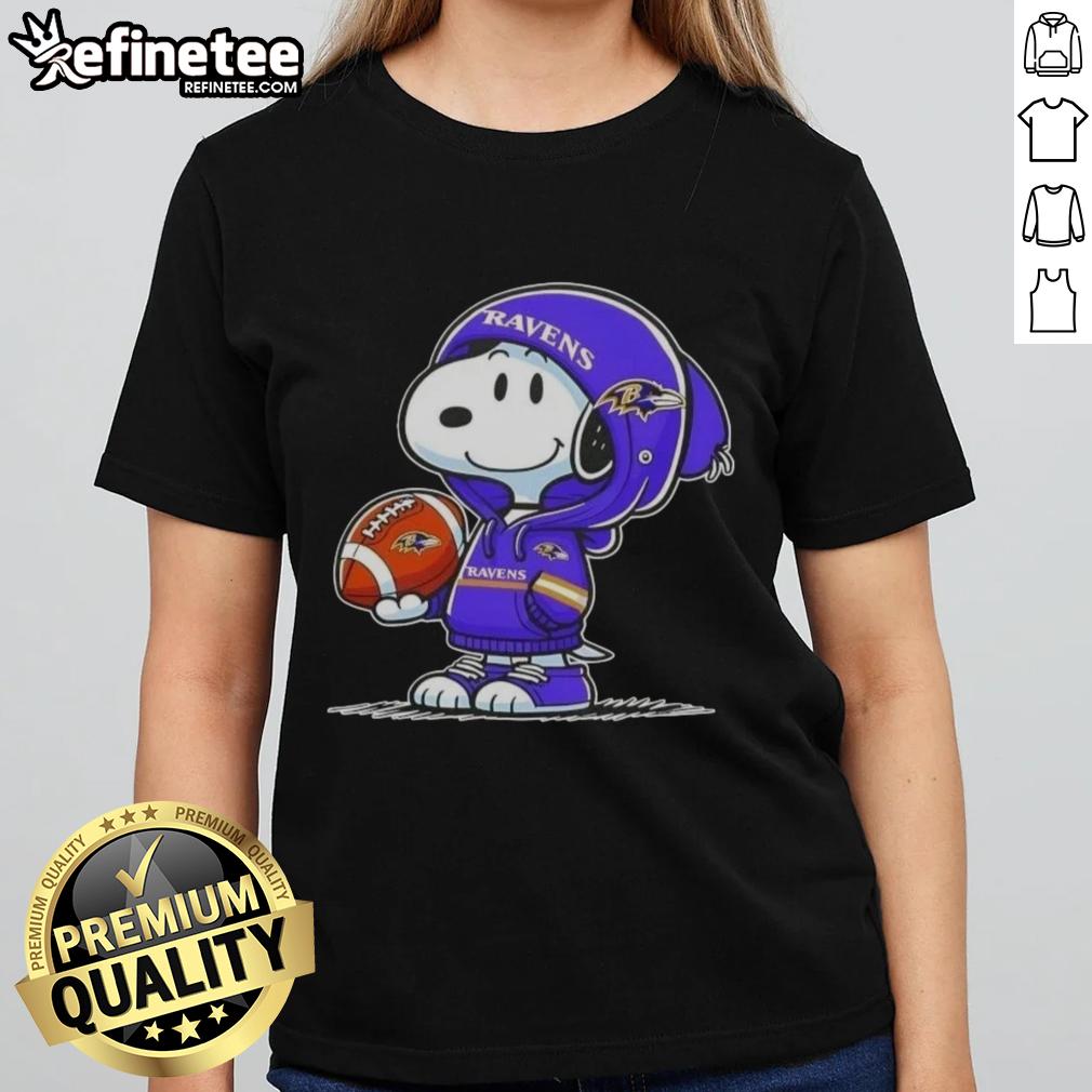 Premium Peanuts Snoopy in a Baltimore Ravens hoodie smiles at fans on a ladies tee, showcasing fun NFL spirit.