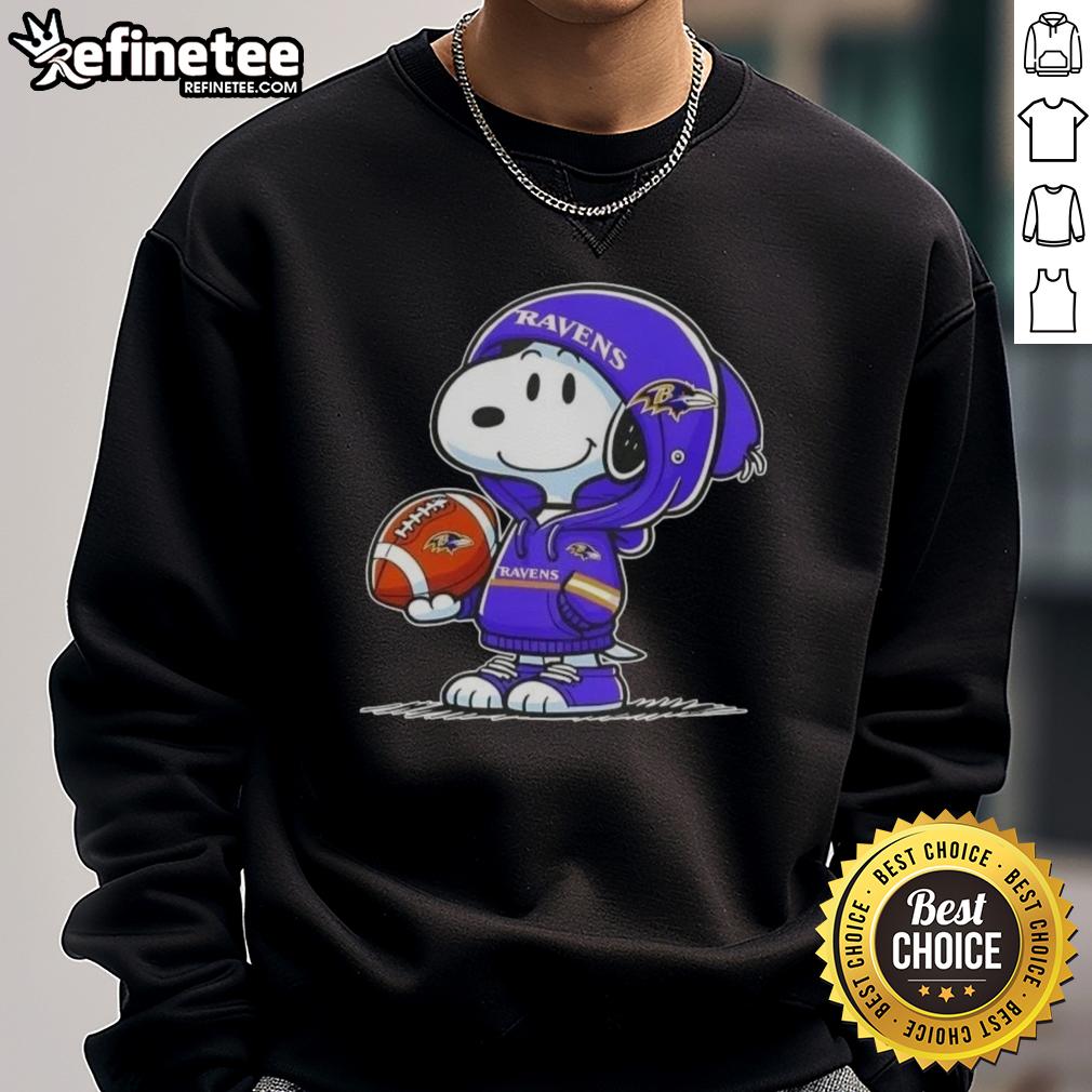 Alt Text: Premium peanuts Snoopy in a Baltimore Ravens hoodie, smiling at fans while wearing a cozy sweatshirt.